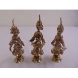Three white metal Far Eastern figurines playing a variety of musical instruments on raised