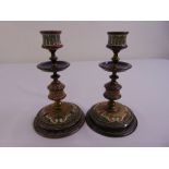 A pair of Royal Doulton table candlesticks on raised circular bases by Frank Butler circa 1870