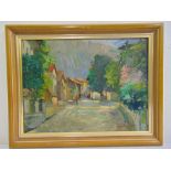 A framed oil on panel of a street scene, indistinctly signed bottom right, 28.5 x 38.5cm