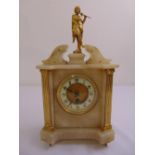 A Victorian alabaster and brass rectangular mantle clock surmounted by a classical figure playing