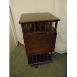 An Edwardian rectangular revolving oak bookcase with slatted sides and drop flap reading table A/F
