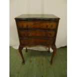A mahogany shaped rectangular chest of drawers on four cabriole legs