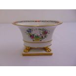An oval Herend cache pot decorated to the sides with sprays of flowers on four claw supports all