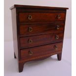 An Edwardian rectangular mahogany apprentice chest the four drawers with brass swing handles and