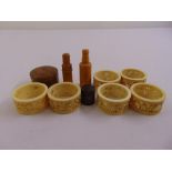 Six carved bone napkin rings and four pieces of treen