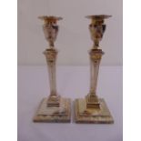A pair of silver plated table candlesticks in the classical style