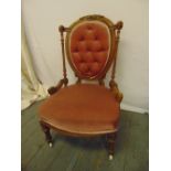 A Victorian gilded wooden boudoir chair, upholstered on turned legs