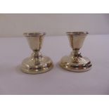 A pair of silver dwarf candlesticks on raised circular bases