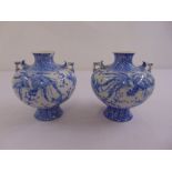 A pair of oriental blue and white vases decorated with birds and flowers, A/F