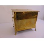 A brass Arts and Crafts rectangular coal scuttle on four cast feet with flat hinged cover