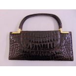 A ladies crocodile skin handbag with carrying handle