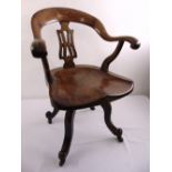 An Edwardian oak captains swivel desk chair
