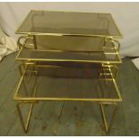 A gilt metal and glass nest of three rectangular tables