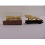 Two 19th century carved figurines a dragon in fitted case and a lion on wooden plinth