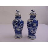 A pair of Chinese blue and white baluster vases with pull off covers