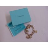 A Tiffany and Co. silver charm bracelet in original packaging