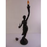 A bronze figurine lamp standard in the form of a topless lady holding a flame on circular base,