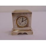 A silver mounted shaped rectangular desk clock with white enamel dial, Birmingham 1920