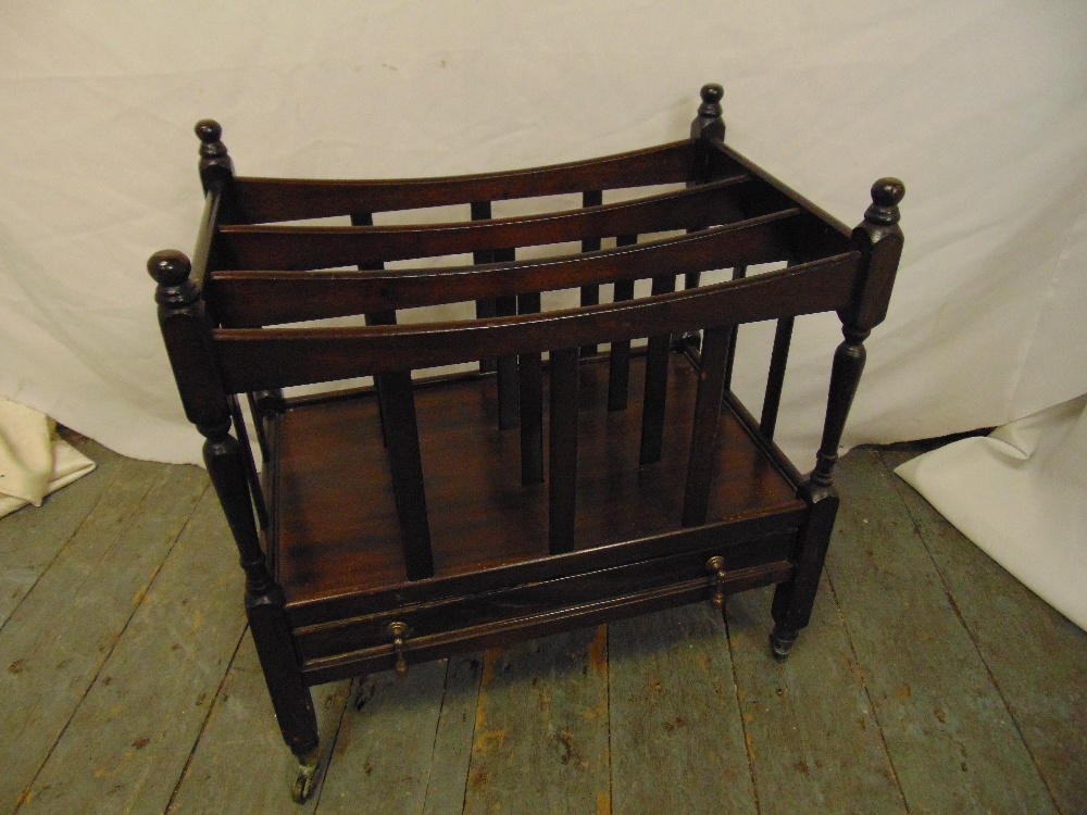 Mahogany rectangular magazine rack with slatted sides on original castors