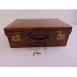 A crocodile skin suitcase of customary form circa 1940