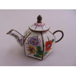 A Chinese enamel hexagonal miniature teapot decorated with flowers and leaves
