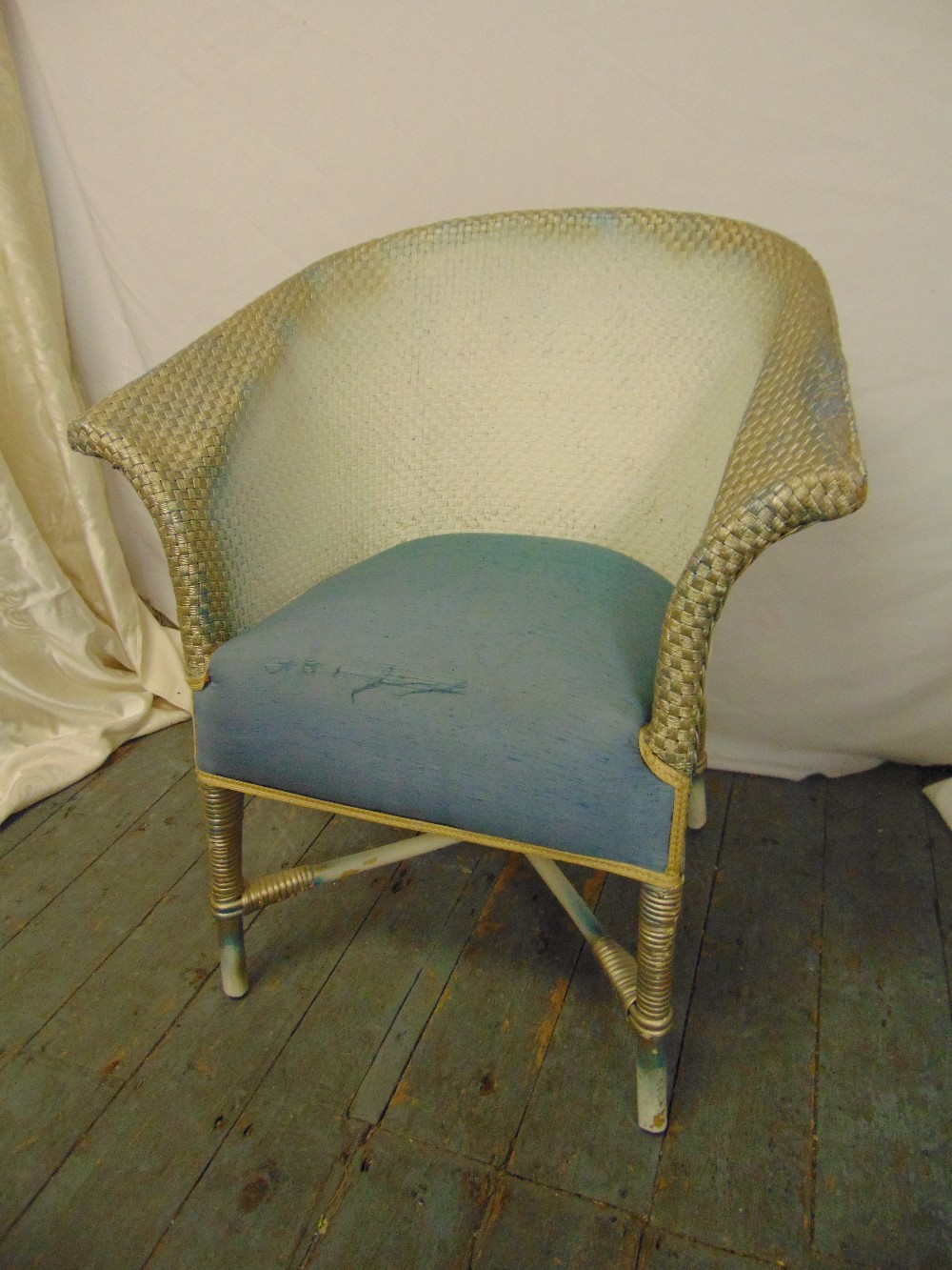 Lloyd Loom chair with upholstered seat on four turned legs