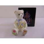 A Royal Crown Derby Christening Teddy, gold seal and marks to the base, to include packaging