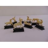 Eight 19th century carved ivory figurines of horses in various poses mounted on wooden plinths