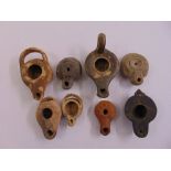 Eight Greek and Roman antique oil lamps of various shape and size