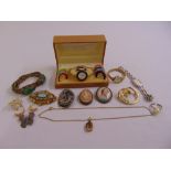 A quantity of costume jewellery to include a Gucci watch, brooches and bracelets