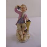 Meissen figurine of a young boy holding grapes, marks to the base