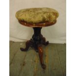 A Victorian mahogany piano stool on three outswept legs with upholstered seat