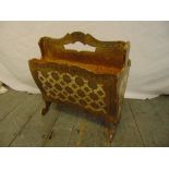 A gilded Florentine wooden magazine rack on scroll legs with pierced carrying handle