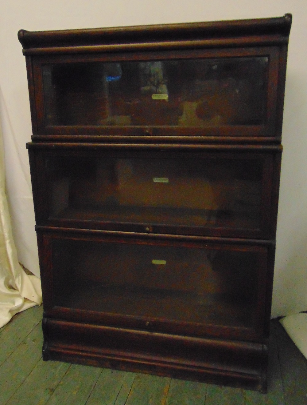 Globe Wernicke mahogany three section bookcase with raised plinth and top section, label to