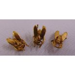Three gold plated dress shirt buttons in the form of insects