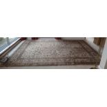 A fawn ground Persian carpet with floral design and repeating motif border, 2.7m x 3.7m