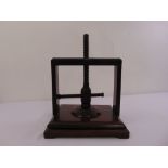 A Victorian mahogany book press of customary form on rectangular base with bracket feet