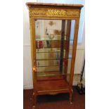 A French kingswood rectangular glazed display cabinet with applied gilded metal mounts, marble top