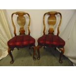 A pair of mahogany and walnut 18th century style dining chairs with upholstered seats and cabriole