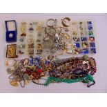 A quantity of costume jewellery to include necklaces, brooches, rings and watches