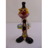 A Murano glass clown holding a ball