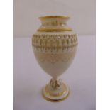 An early 20th century Royal Worcester gilt and white vase on raised circular foot