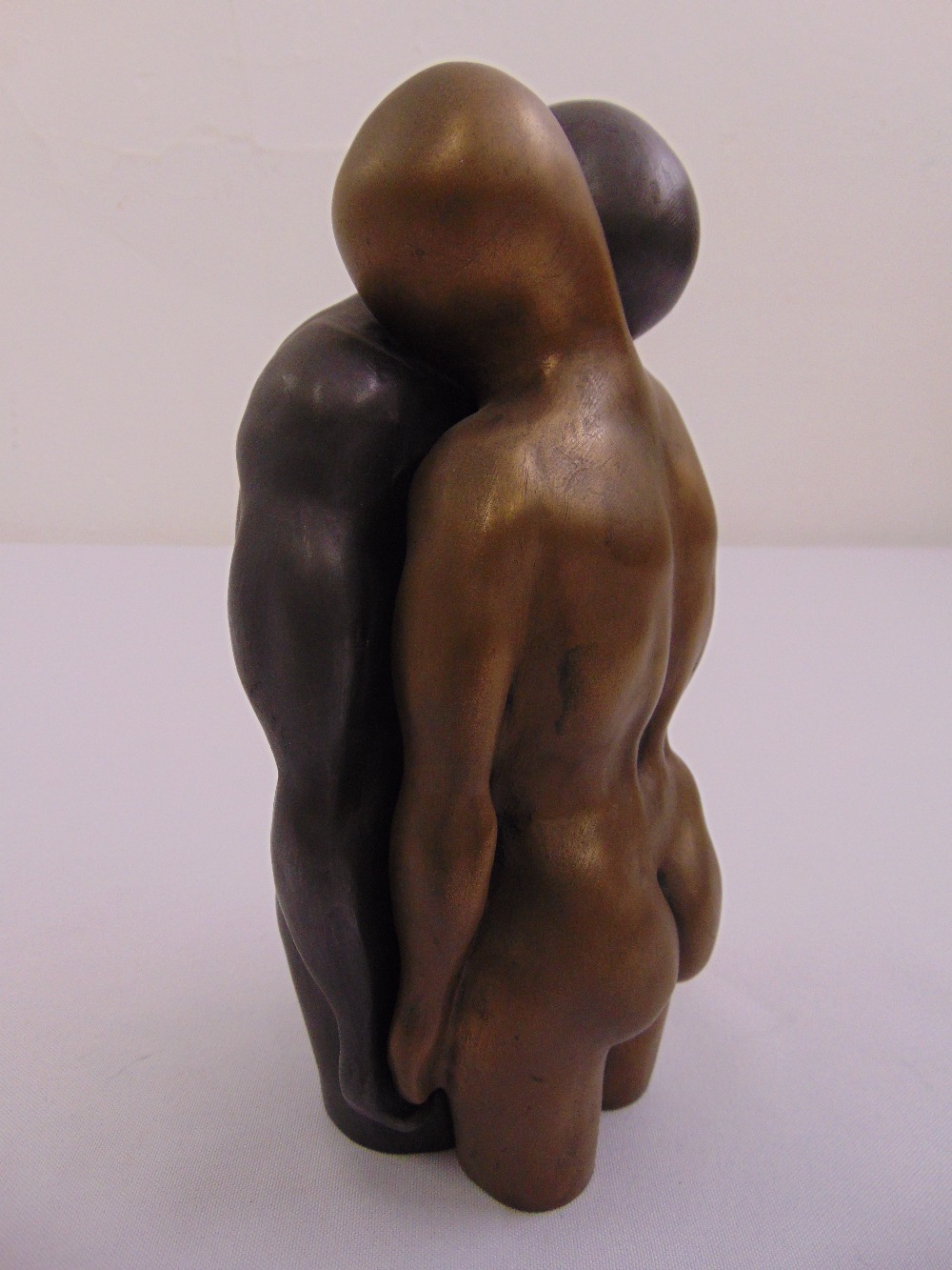 A cast bronze two part figurine of a man and lady