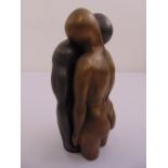 A cast bronze two part figurine of a man and lady