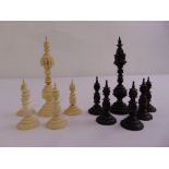Eleven 19th century carved hardwood and ivory chess pieces
