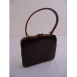 An Art Deco crocodile skin ladies evening bag with swing handle