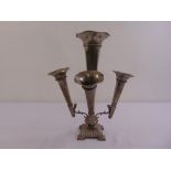 A pewter four branch epergne with detachable cones on raised square base