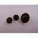 A Victorian garnet and gold ring and a pair of garnet earrings set in gilt metal