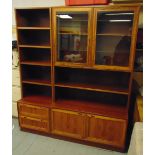 A late 20th century Danish rosewood wall unit comprising hinged glazed doors, shelves and