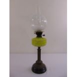 A Victorian brass and glass oil lamp on raised circular base